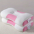 White and pink baby pillow on a neutral background