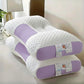 White and purple orthopedic pillow on a bed in a bedroom setting
