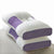 White and purple pillow on a light gray surface
